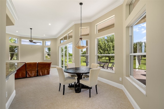 dining area with light tile patterned floors, crown molding, and plenty of natural light