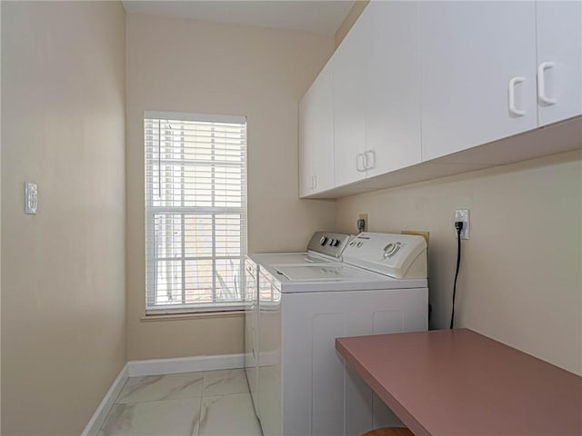 washroom featuring cabinets and washing machine and dryer