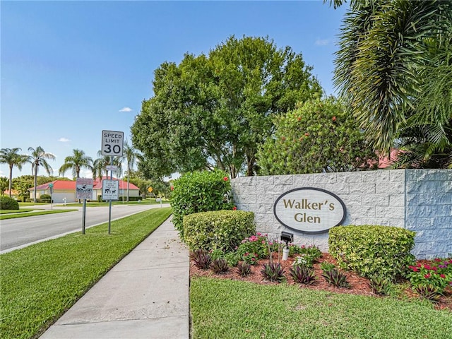 community sign featuring a lawn