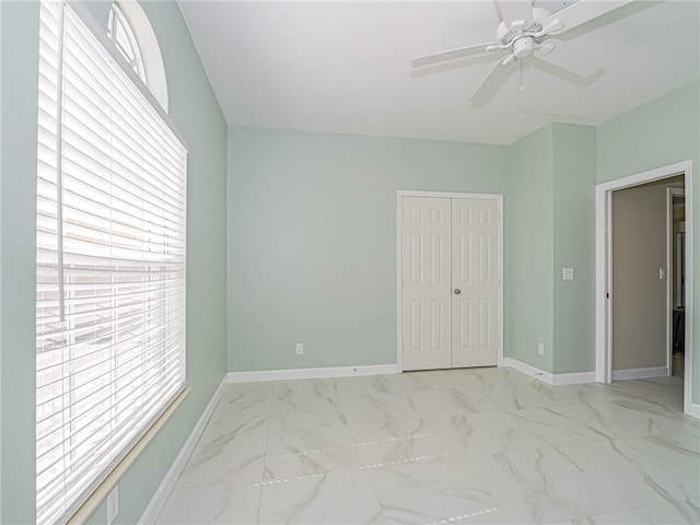 unfurnished room with ceiling fan