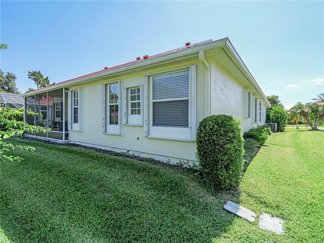 view of side of home featuring a lawn