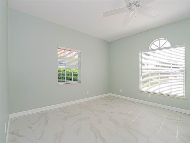 spare room with plenty of natural light and ceiling fan