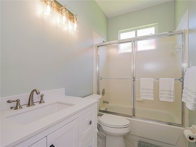 full bathroom with tile patterned floors, vanity, toilet, and shower / bath combination with glass door