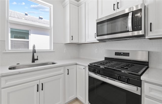 1209 Harper Way Unit 008, Vero Beach, FL 32960 - kitchen featuring stainless steel appliances, a sink, tasteful backsplash, and white cabinets