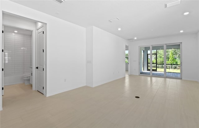 1209 Harper Way Unit 008, Vero Beach, FL 32960 - empty room featuring baseboards, recessed lighting, and light wood-style flooring