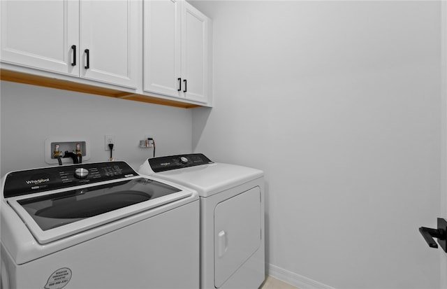 1209 Harper Way Unit 008, Vero Beach, FL 32960 - laundry area with cabinet space, washing machine and clothes dryer, and baseboards