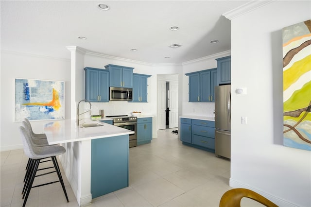 kitchen with appliances with stainless steel finishes, sink, a breakfast bar area, decorative backsplash, and kitchen peninsula