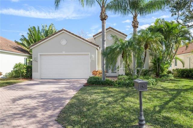 view of front of property with a garage and a front lawn