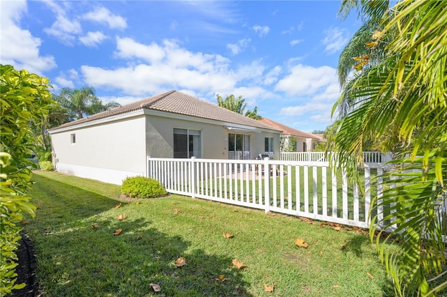 view of side of property with a yard