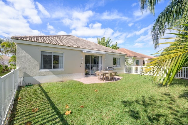 rear view of house with a yard and a patio area