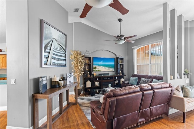 living room with vaulted ceiling, baseboards, a ceiling fan, and wood finished floors