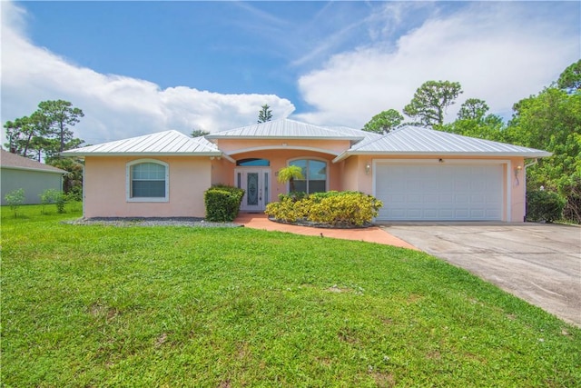 ranch-style house with a standing seam roof, metal roof, concrete driveway, an attached garage, and stucco siding