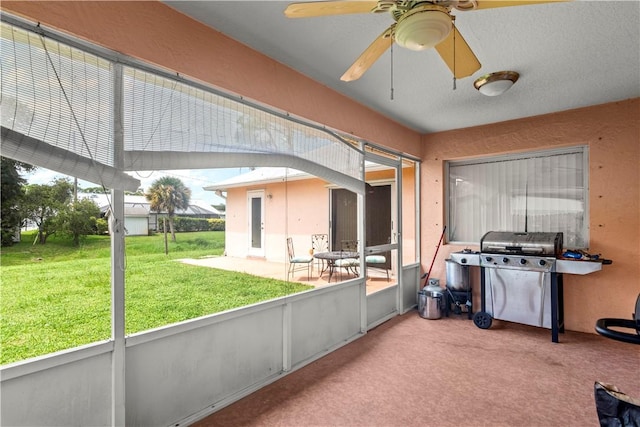 sunroom / solarium with a ceiling fan