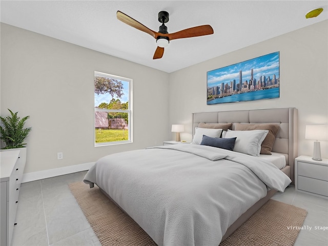 tiled bedroom featuring ceiling fan