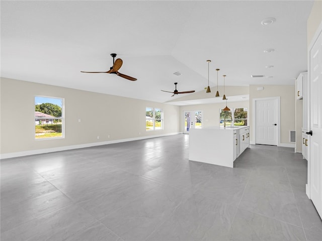 interior space with ceiling fan, lofted ceiling, and sink