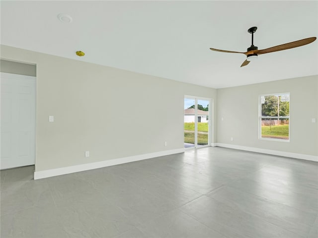 empty room featuring ceiling fan and a healthy amount of sunlight