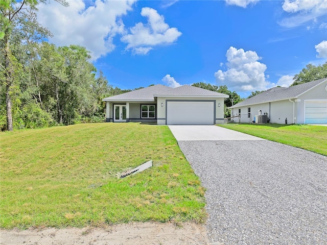 ranch-style house featuring central AC, a garage, and a front lawn