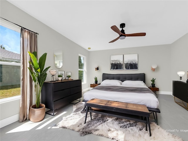 bedroom featuring ceiling fan, lofted ceiling, and multiple windows