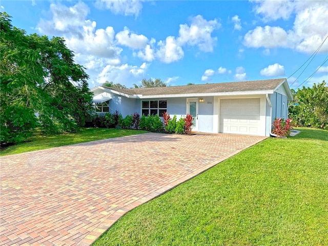 ranch-style home with a garage and a front lawn