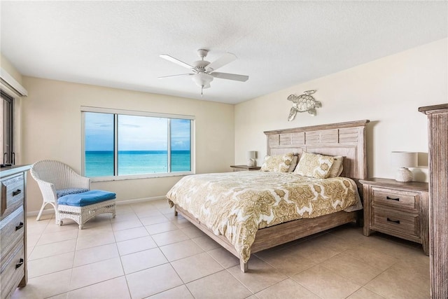 bedroom featuring light tile patterned floors, baseboards, and a ceiling fan