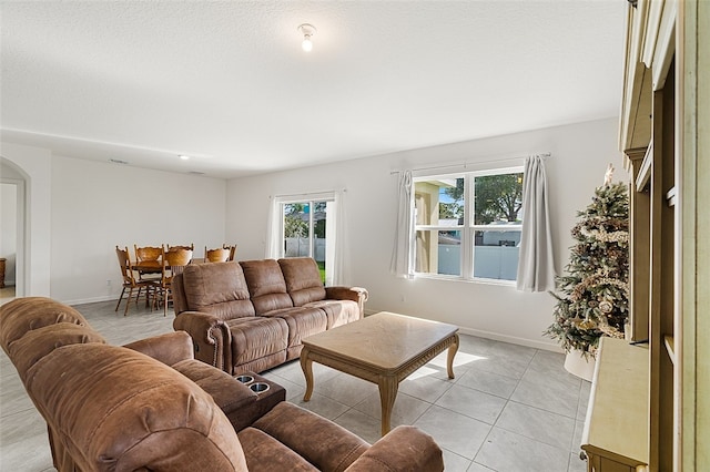 living room featuring plenty of natural light and light tile patterned flooring