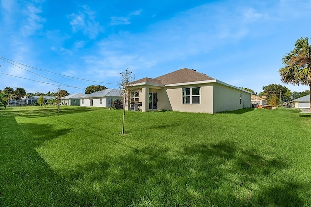 rear view of property with a lawn