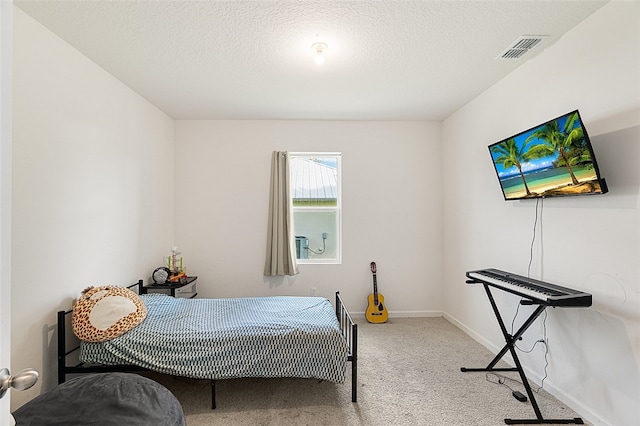 carpeted bedroom featuring a textured ceiling