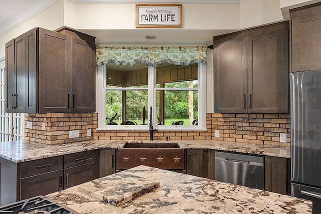 kitchen with stainless steel appliances, sink, and dark brown cabinetry