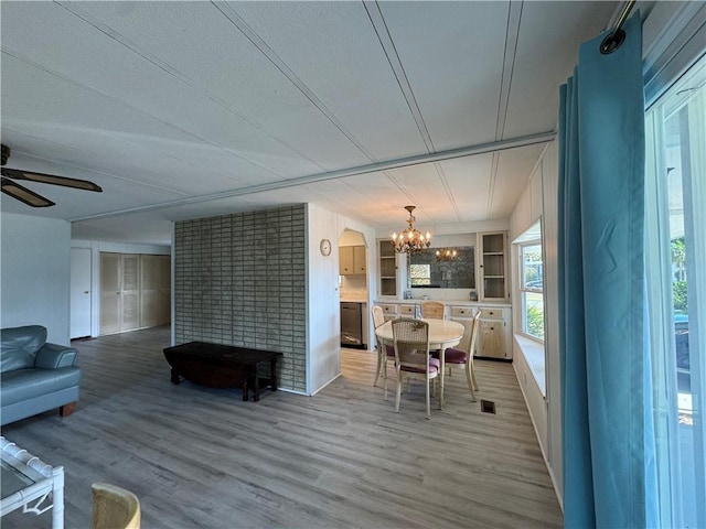 939 Laurel Cir, Barefoot Bay, FL 32976 - living area with arched walkways, ceiling fan with notable chandelier, wood finished floors, and visible vents
