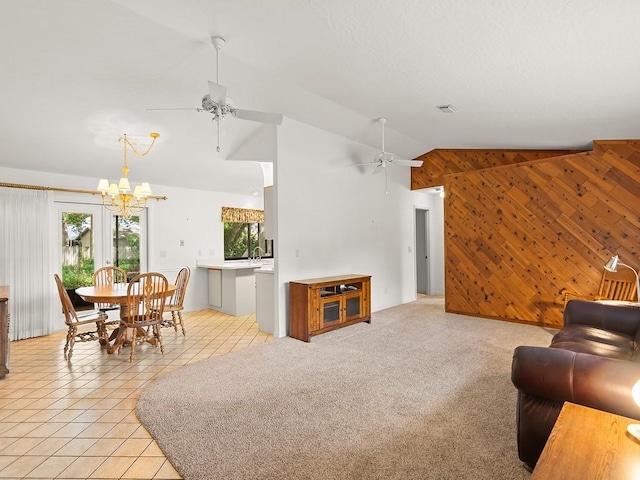 321 Browning Ter, Sebastian, FL 32958 - living area featuring wooden walls, ceiling fan, vaulted ceiling, a chandelier, and light tile patterned floors