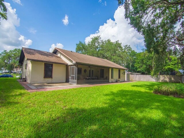 321 Browning Ter, Sebastian, FL 32958 - back of house with a sunroom, a patio area, a ceiling fan, and stucco siding