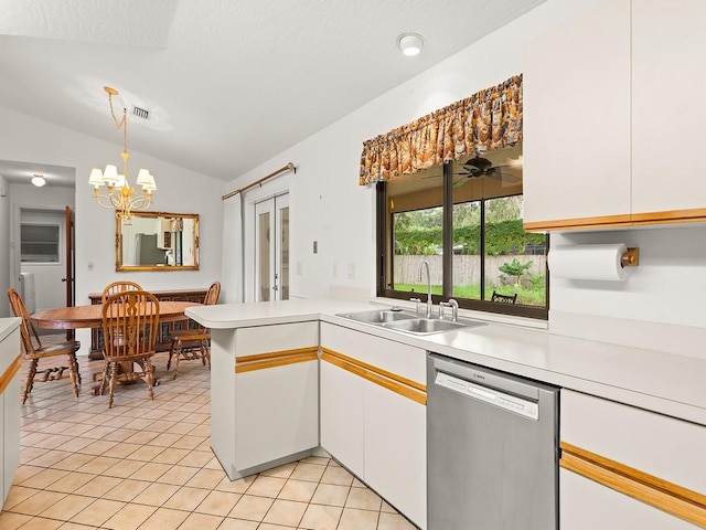 321 Browning Ter, Sebastian, FL 32958 - kitchen featuring dishwasher, vaulted ceiling, light countertops, white cabinets, and a chandelier
