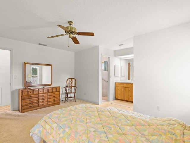 321 Browning Ter, Sebastian, FL 32958 - bedroom with light colored carpet, connected bathroom, and a ceiling fan