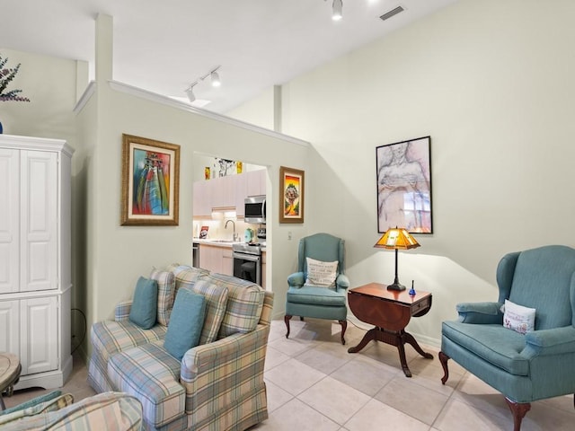 636 Centre Ct SW Unit 102, Vero Beach, FL 32962 - living area with track lighting and light tile patterned floors