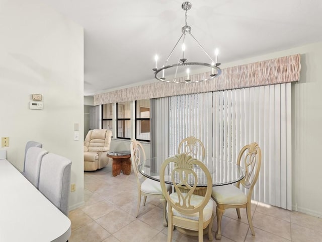 636 Centre Ct SW Unit 102, Vero Beach, FL 32962 - dining space with a chandelier, light tile patterned floors, and baseboards