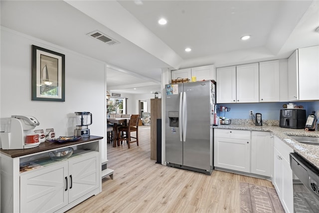 kitchen featuring light stone countertops, light wood-type flooring, white cabinetry, and appliances with stainless steel finishes