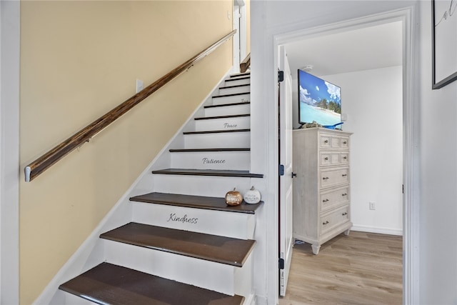 stairs featuring hardwood / wood-style flooring