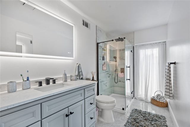 bathroom with vanity, toilet, and an enclosed shower