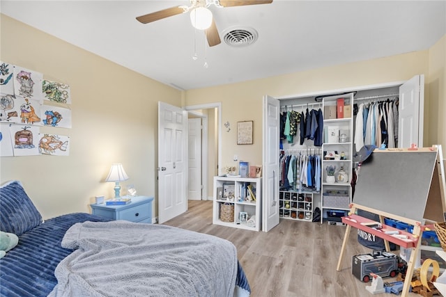 bedroom featuring ceiling fan, a closet, and light hardwood / wood-style floors