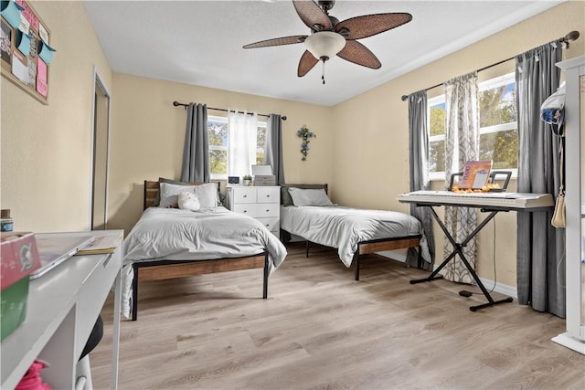 bedroom with ceiling fan and light hardwood / wood-style flooring