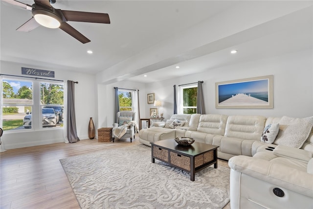 living room featuring light wood-type flooring and ceiling fan