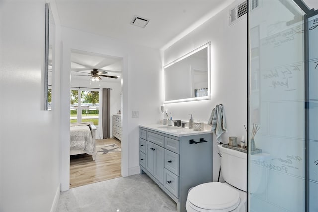 bathroom featuring vanity, toilet, and ceiling fan