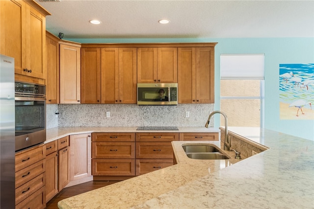 kitchen featuring backsplash, sink, appliances with stainless steel finishes, and dark wood-type flooring