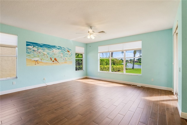 empty room with ceiling fan and dark wood-type flooring