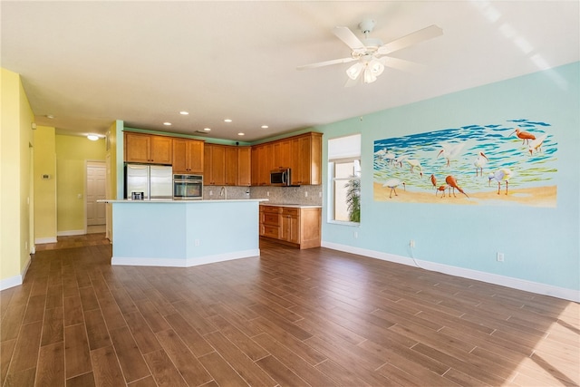 kitchen featuring backsplash, a kitchen island, dark hardwood / wood-style flooring, and stainless steel appliances