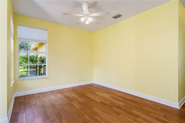 spare room with ceiling fan and hardwood / wood-style flooring