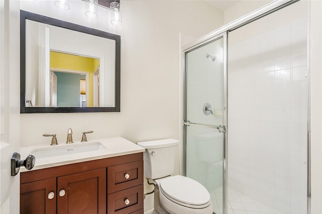 bathroom with vanity, an enclosed shower, and toilet