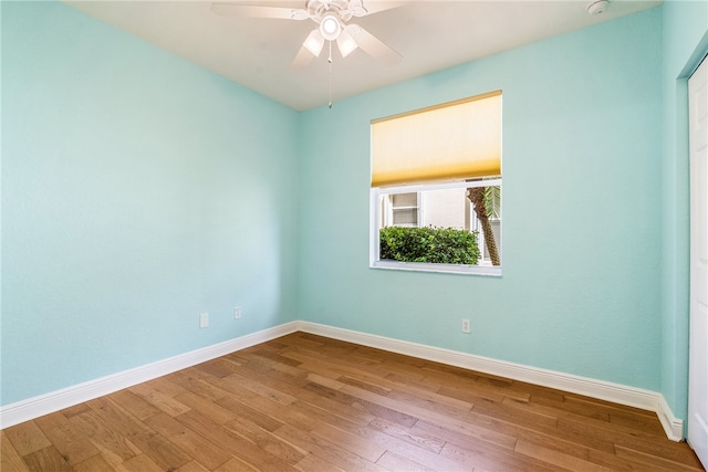 empty room with ceiling fan and light hardwood / wood-style flooring