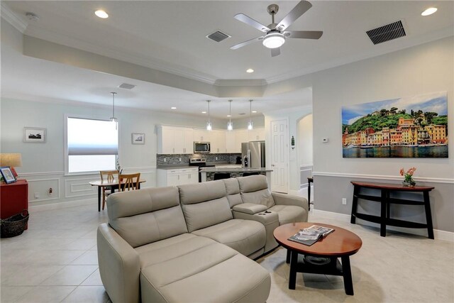 6005 Bella Rosa Ln, Vero Beach, FL 32966 - living area featuring ceiling fan, ornamental molding, recessed lighting, a tray ceiling, and arched walkways