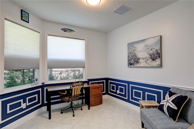 6005 Bella Rosa Ln, Vero Beach, FL 32966 - home office with a wainscoted wall and a textured ceiling
